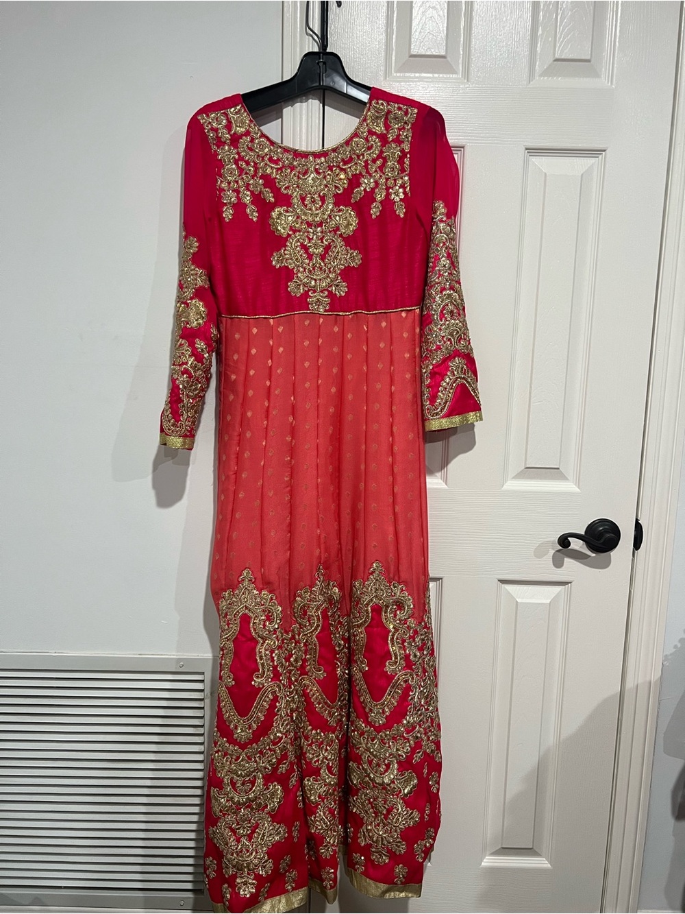 Sari vibrant red/coral long-sleeved dress adorned with intricate gold embroidery